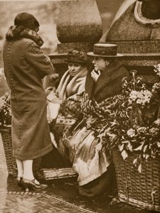 Flower sellers huddle and chat at Piccadilly Circus by English Photographer